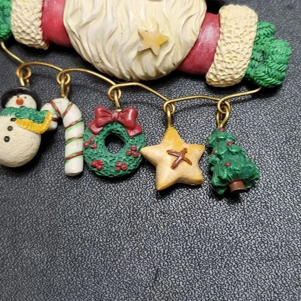 Charm holding Santa holiday brooch